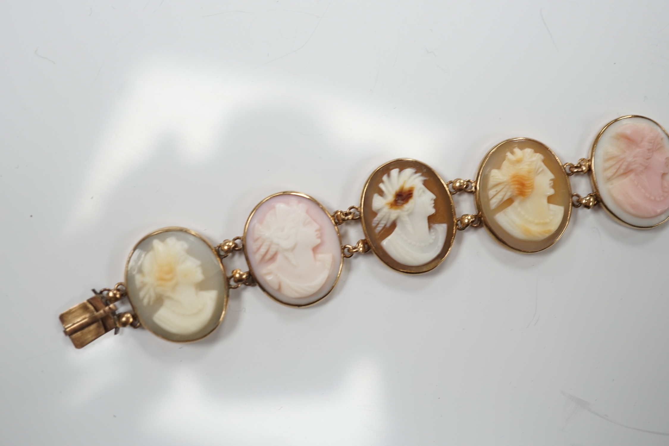 A yellow metal mounted ten stone oval cameo shell set bracelet, each carved with bust of a lady to sinister, 16cm, gross weight 13.9 grams.